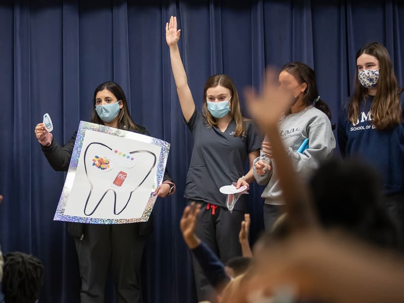 First-year School of Dentistry students, from left, Mary Beth Gillespie, Kathryn Butler, Landon Natthews and Mary Agnes Mestayer entertain Pecan Park Elementary students with lessons on oral health.