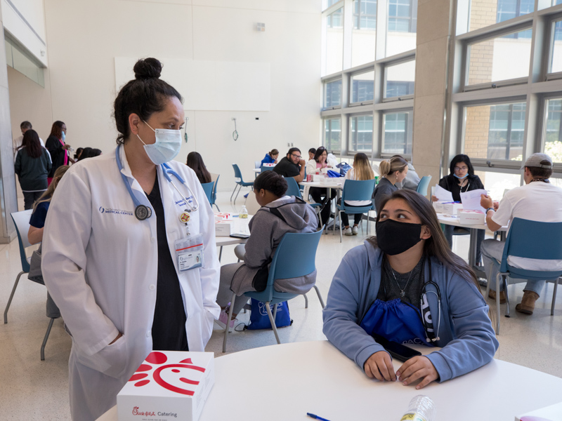 Dr. Christina Wallace, left, an internal medicine resident at UMMC and the first representative of the Mississippi Band of Choctaw Indians to earn a medical degree, is a role model for Choctaw Central High students like Katelyn Taylor, right. Jay Ferchaud/ UMMC Communications