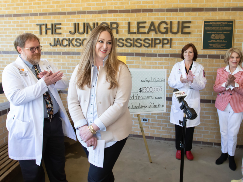 Junior League of Jackson President Katie Lightsey Browning smiles during a news conference Tuesday announcing the $500,000 donation from the Junior League of Jackson to the Center for Cancer and Blood Disorders at Children's of Mississippi. Applauding are, from left, Dr. Anderson Collier, director of the center and chief of pediatric hematology-oncology; Dr. Mary Taylor, Suzan B. Thames Chair and professor of pediatrics; and Suzan Thames, an early supporter of the center. Melanie Thortis/ UMMC Communications