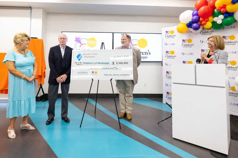 From left, Gertrude C. Ford Foundation president Cheryle Sims, director Stephen Sims, and vice president and treasurer John Lewis present a donation of $2.5 million to the Campaign for Children's of Mississippi as Dr. LouAnn Woodward, vice chancellor for health affairs and dean of the School of Medicine, looks on. Melanie Thortis/ UMMC Communications 