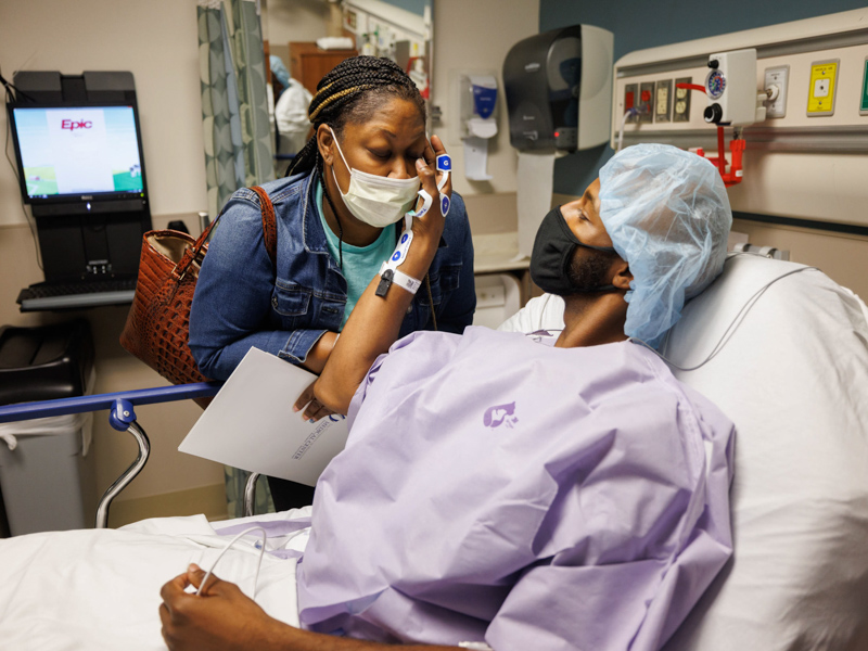 Tawanna Davis gets a loving pat from her son, Quinten Hogan, moments before Hogan was rolled into surgery and she was prepped to follow him. The 25-year-old donated his left kidney to his mom, who copes with diabetes and hypertension. Joe Ellis/ UMMC Communications 
