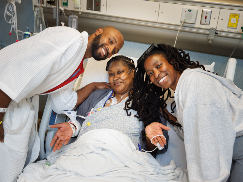 From left, Quinten Hogan; Hogan's mom, Tawanna Davis; and Hogan's girlfriend, Taylor Brown, share a moment following Davis' transplant surgery. Hogan donated his left kidney to his mom. Joe Ellis/ UMMC Communications 