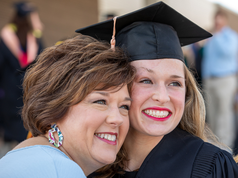 Bachelor of Science in Nursing graduate Abbey Climer smiles with her mom Stacy for a pre-ceremony photo.