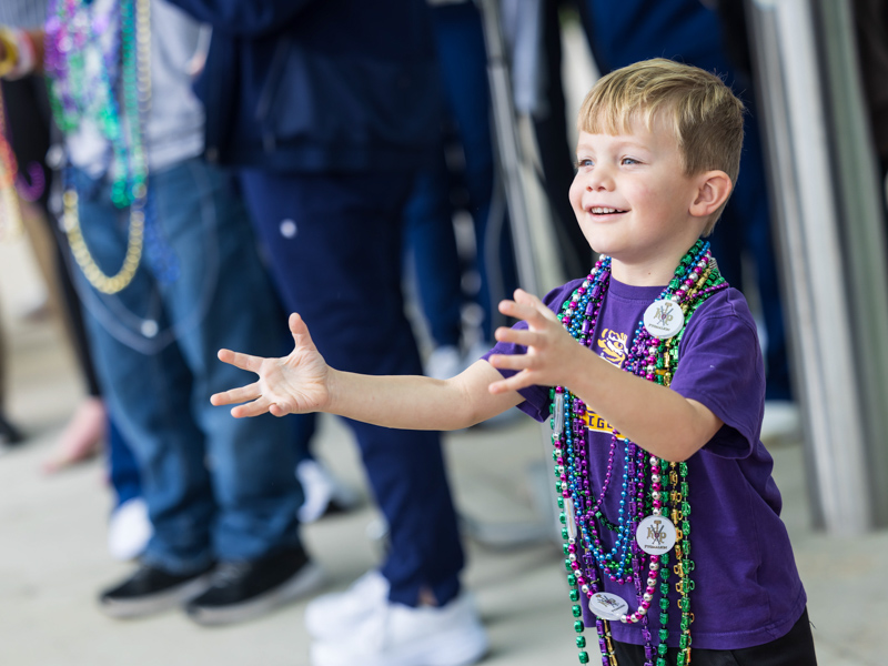 Children's of Mississippi patient Hatton Ashley of Bastrop, Louisiana, is ready to catch beads at the Mississippi Department of Public Safety Mardi Gras parade Tuesday. Melanie Thortis/ UMMC Communications 