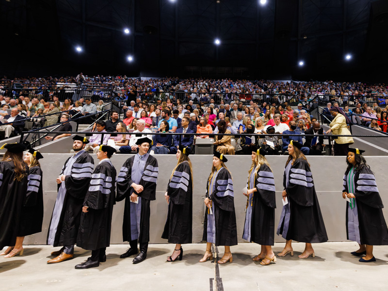 Candidates for the degree of Doctor of Occupational Therapy make their way to the stage to receive their degrees and hoods at commencement. Joe Ellis/ UMMC Communications 