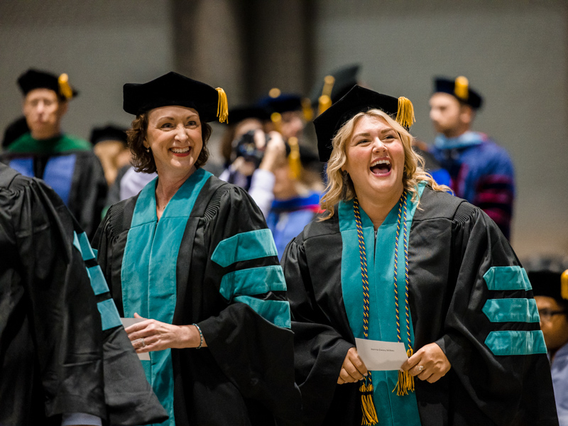 Mandy Scott and Jeanna Wilkes celebrate graduating with their doctor of health administration degree. Lindsay McMurtray/ UMMC Communications 