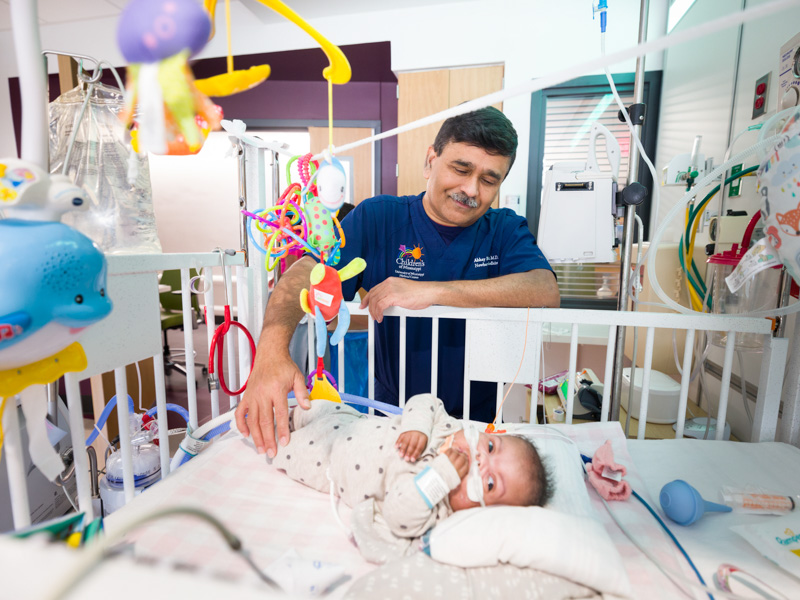 In this file photo from May, Dr. Abhay Bhatt, professor of pediatrics and director of research in the Division of Neonatology, visits Marian Johnson, a patient in the Kathy and Joe Sanderson Tower at Children's of Mississippi. Bhatt is principal investigator of the Neonatal Research Network, comprised of 15 medical centers across the country conducting collaborative, multi-site clinical trials and observational studies on newborn infants, providing evidence to guide clinical practice. NIH is awarding UMMC $2.1 million over seven years to fund the research. 