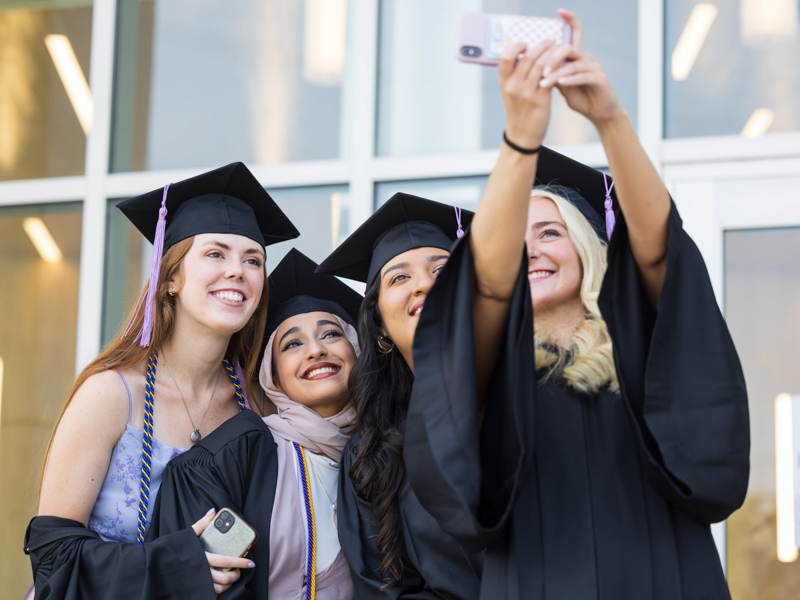 Dental hygiene graduates, from left, Madeline Guest, Kathy Ahmad, Yarenni Valdez and Mary Breland Cross take a selfie prior to commencement.  Melanie Thortis/ UMMC Communications 