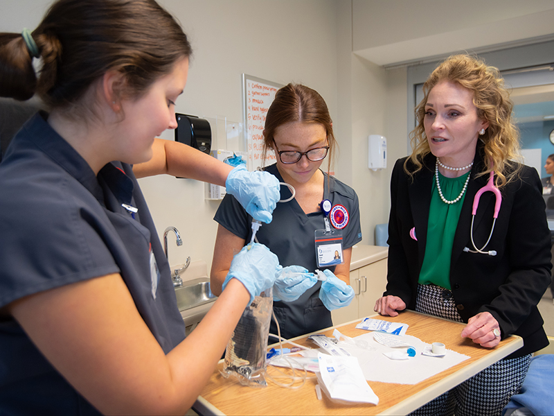 Dr. Leigh Holley, associate professor of nursing and assistant dean for School of Nursing's Oxford Instructional Site, works with students at the South Oxford Center in this 2022 photo. Photo by Kevin Bain/The University of Mississippi Marketing Communications