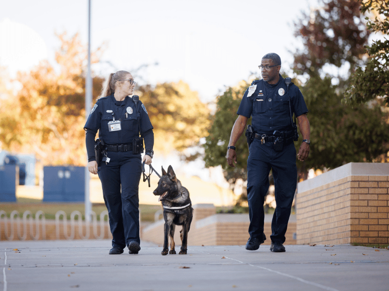 UMMC PD officer and K9 handler Christie Shoemaker, left, takes Law for a walk with Officer Gerri Green.