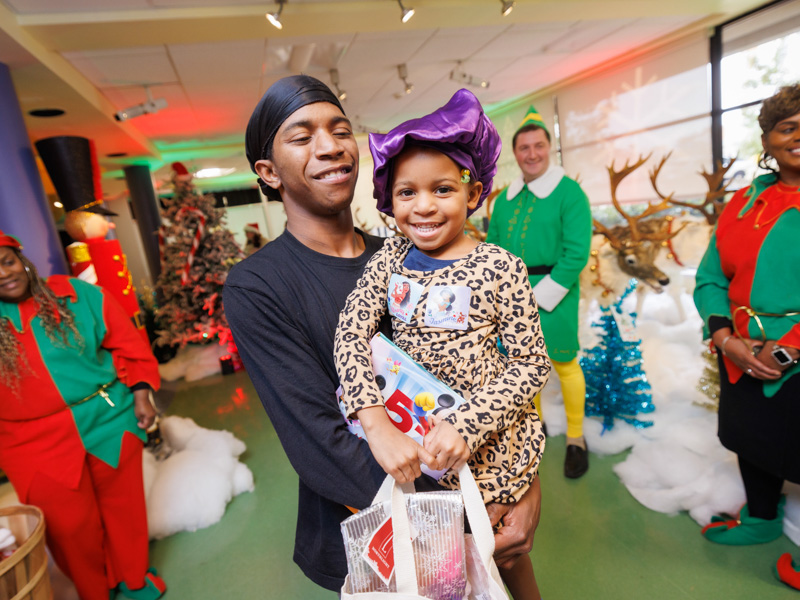 Trinity Petty of West Point and her dad Terence Petty smile during BankPlus Presents Winter Wonderland at Children's of Mississippi. Joe Ellis/ UMMC Photography 