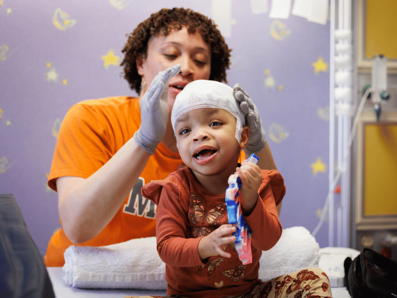 Anderson finishes preparing patient True Burns of Jackson for an EEG at the Comprehensive Epilepsy Center at Children's of Mississippi.