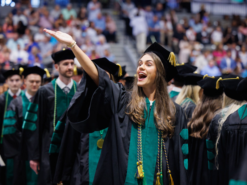 Doctor of Medicine candidate Brittany Corder spots a a familiar face, or faces, in a Mississippi Coliseum crowd numbering in the thousands. Joe Ellis/ UMMC Communications 
