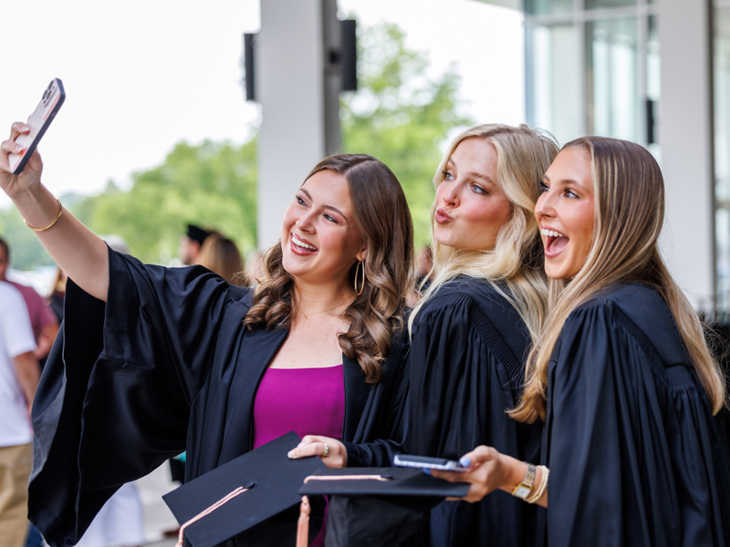 It's selfie time for Bachelor of Science in Nursing graduates, from left, Kennedy Nations, Grace Parker and Hayden Ray. Jay Ferchaud/ UMMC Communications 