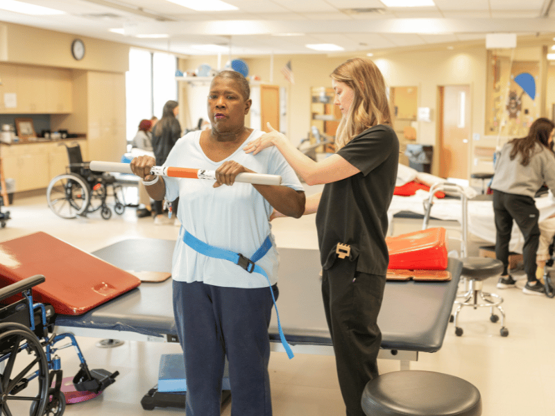 Hurrod works with Lindsey Klaus, nurse at Methodist Rehabilitation Center, during physical therapy.