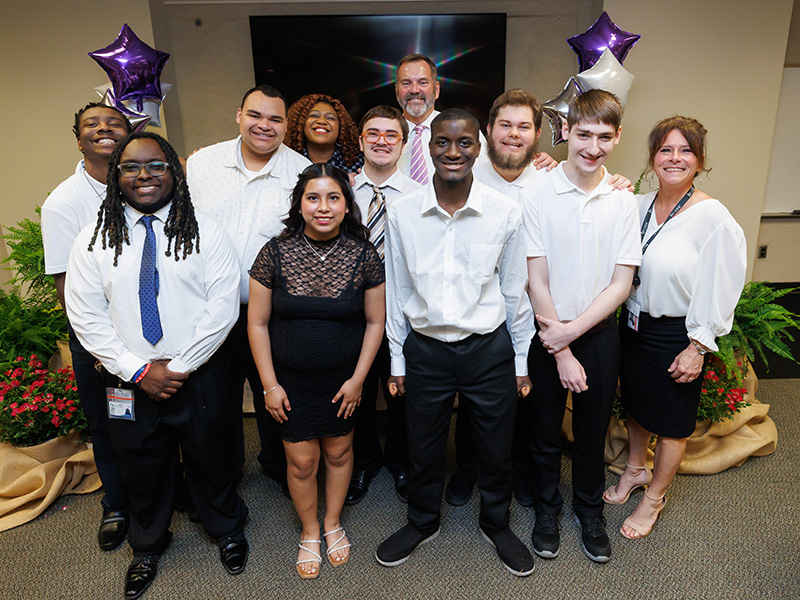 Front row, from left, Project SEARCH graduates Creighton Johnson, Kimberly Mariano, Nick Fletcher, Logan Crane, Christina Guarino; back row, C.J. Walker, Geoffrey Smitson, Jasmine Lee, Zach Batiste, Tommy Burnham and Neal Carpenter pose after the ceremony. Brady Bennett, who was unable to attend, was also among those graduating from the program.