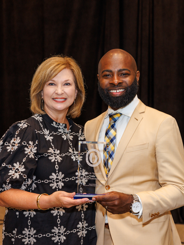 Early Career Achievement Awardee, Dr. Justin Turner, receives recognition from Dr. LouAnn Woodward.