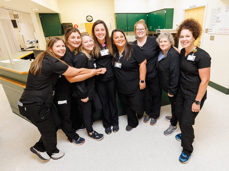 Jessica Greer shares a hug with her colleagues: Cassie Millwood, Julia Trimble, Julianna Holland, Jessica Greer, Megan Haley, Brooklyn Orear, Bonnie Williams, and Heather Realmuto.