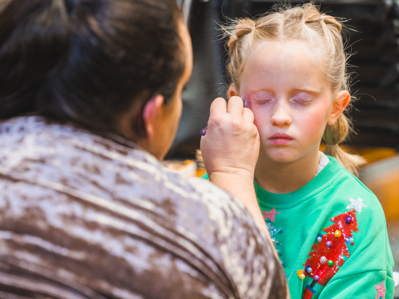 Children's of Mississippi patient Katherine Hoff gets an eyeshadow touch-up before Mistletoe Marketplace's Welcome to New York! Tween Fashion Show.