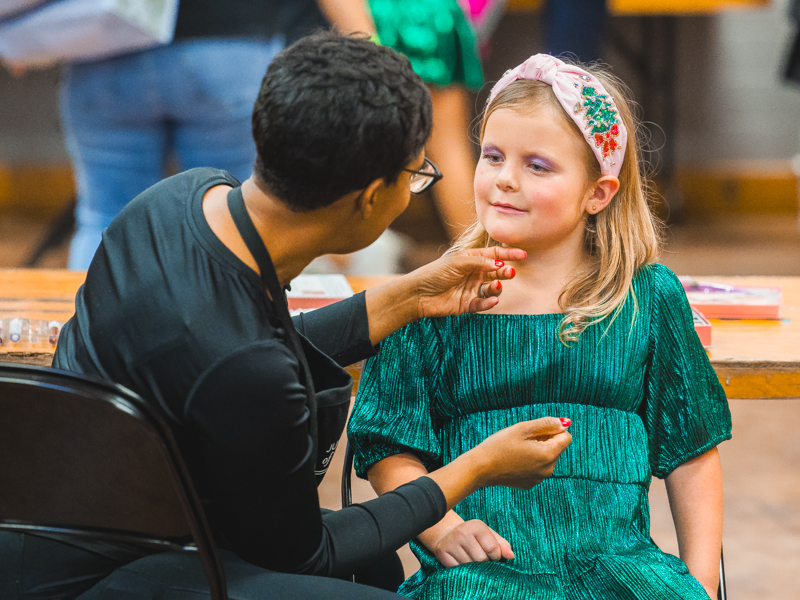 Ila Helm wears holiday makeup to go with the shimmery dress she modeled in the Tween Fashion Show.