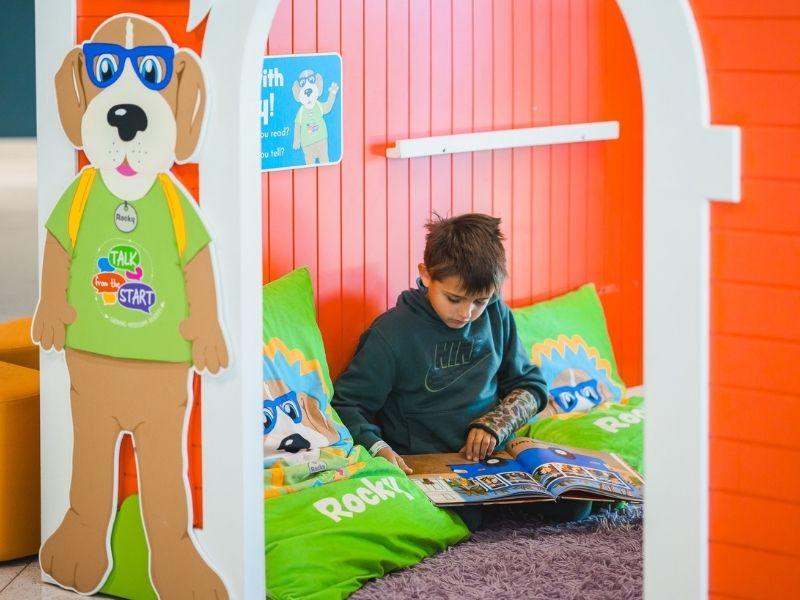 Children's of Mississippi patient Luke Starkey of Clinton reads inside Rocky's House.