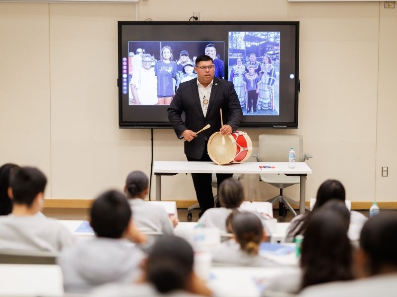 Using a drum, Chief Cyrus Ben produces a sound like "the heartbeat of our people."