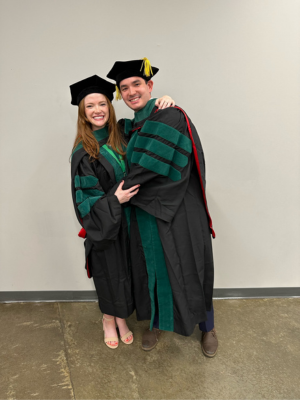 Harkins with fiance, Dr. Gracie Hoggard, don caps and gowns at their School of Medicine commencement ceremony.