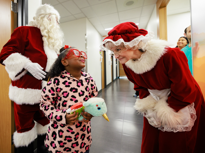 Children's of Mississippi patient Janiyah Lewis of Jackson enjoys a visit with Mrs. Claus. Joe Ellis/ UMMC Communications