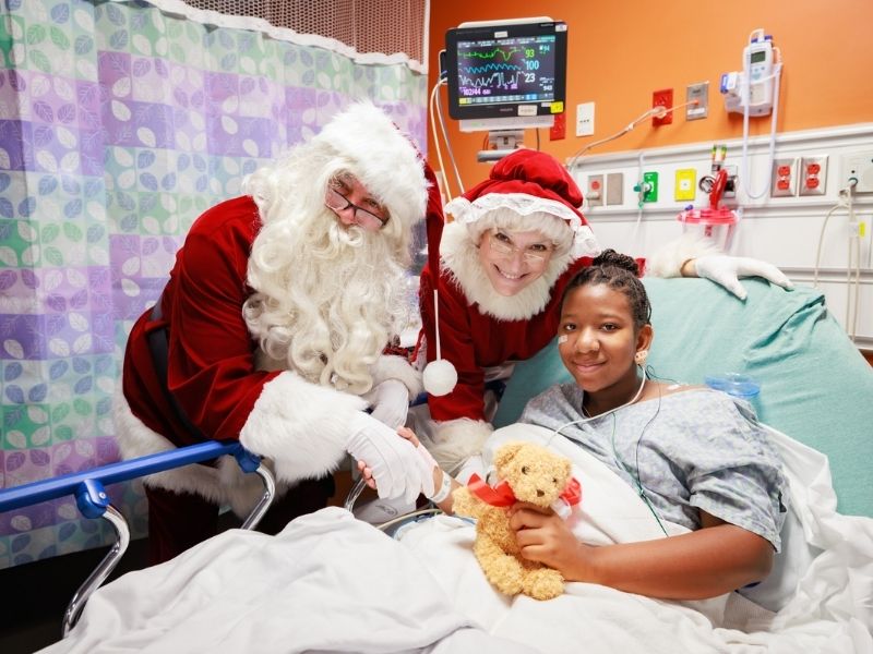 Santa and Mrs. Claus stop for a photo with Children's of Mississippi patient Melanie Smith of Canton.