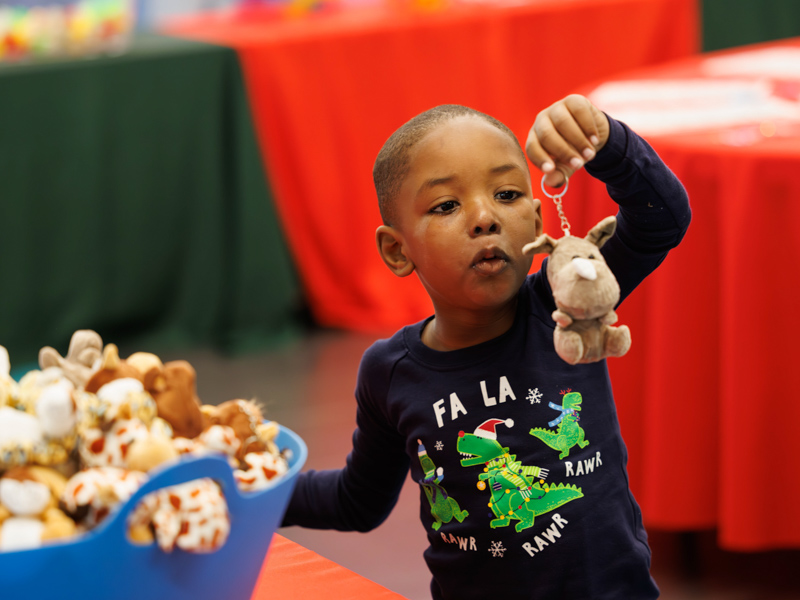 Children's of Mississippi patient Ladell Hawkins of Brookhaven chooses a stuffed rhinoceros for his Christmas stocking. Melanie Thortis/ UMMC Communications 