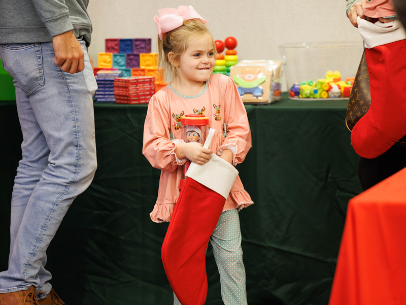 Madalyn Smith of Brookhaven fills a Christmas stocking with gifts from Friends of Children's Hospital. Melanie Thortis/ UMMC Communications 