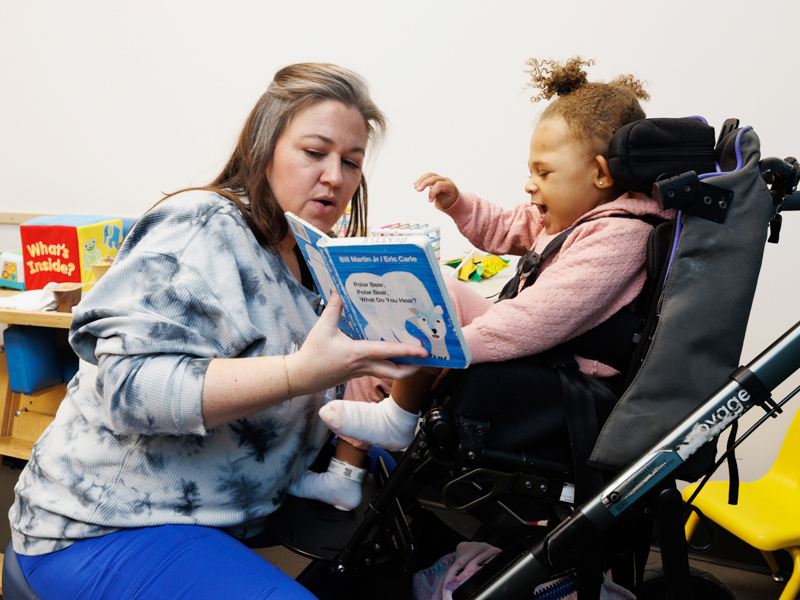 Celina Robinson of Crystal Springs squeals with delight during a speech therapy session with Krissy Beattie, speech therapist, at Children's Rehabilitative Services' new location.