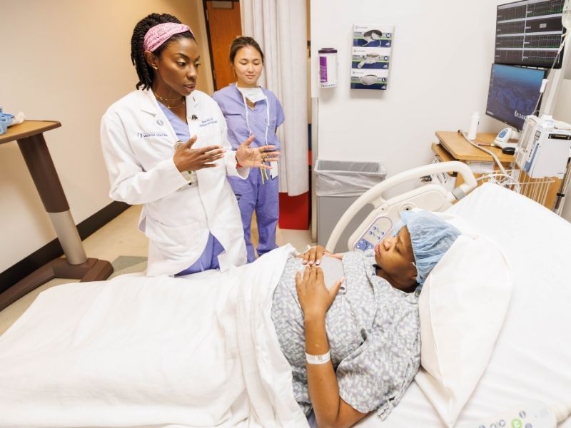 Bell, left, accompanied by third-year medical student Ann Truong, gives patient Marie Lee of Jackson information about the latter's upcoming C-section at UMMC last fall. "I got a good vibe from her," Lee said later. "She's open and gets straight to the point."