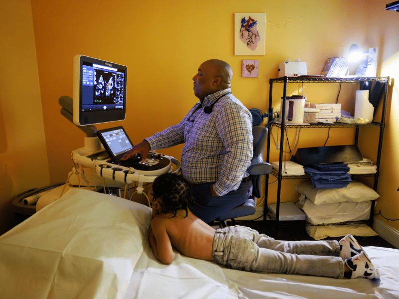 Children's of Mississippi patient Jerome Brooks of Macon watches as his cardiologist, Dr. Kalyl Cable, analyzes his echocardiogram.