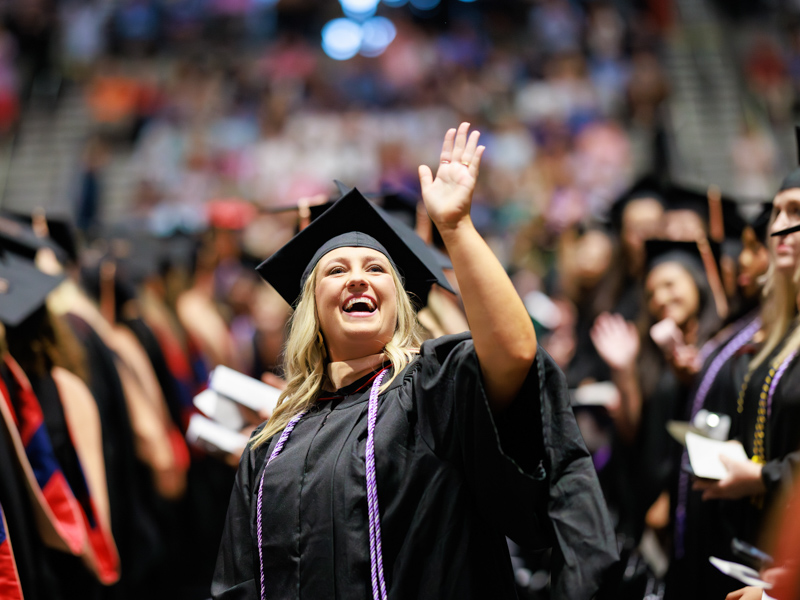 Masters of Science in Nursing graduate Janna Suzann Garrett waves. Joe Ellis/ UMMC Communications