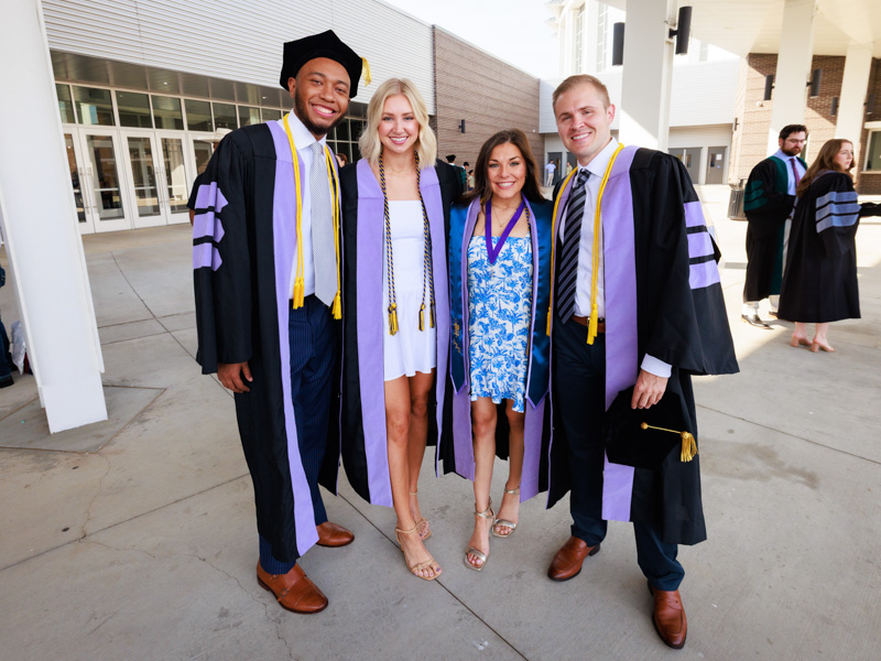 Dental graduates Derrick Burt, Bayley Graves, Ashton Murrah, and Jacob Fanning pose for a photo before the ceremony. Joe Ellis/ UMMC Communications