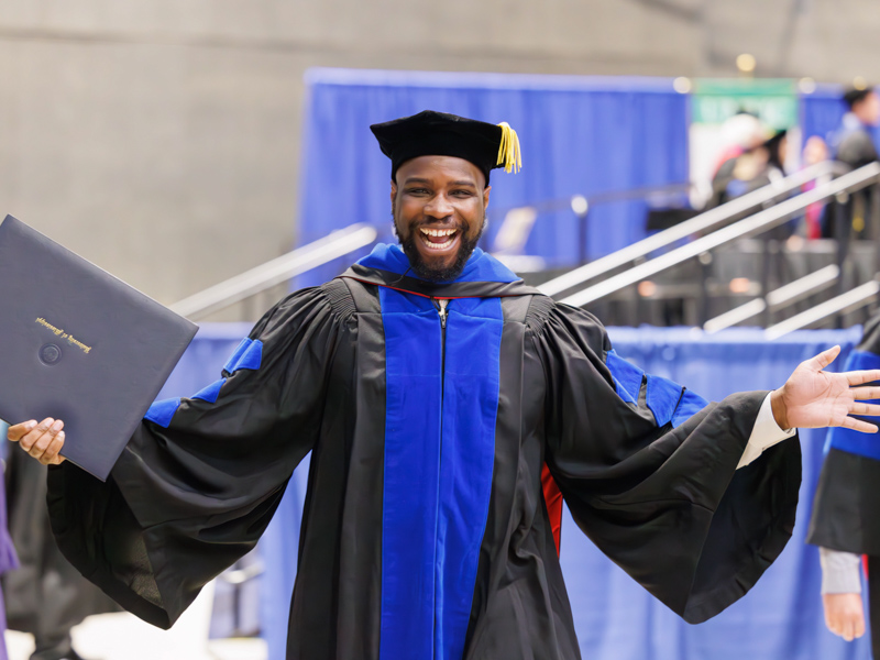 PhD in experimental therapeutics and pharmacology recipient Adesanya Akinleye is all smiles after receiving his degree. Melanie Thortis/ UMMC Communications