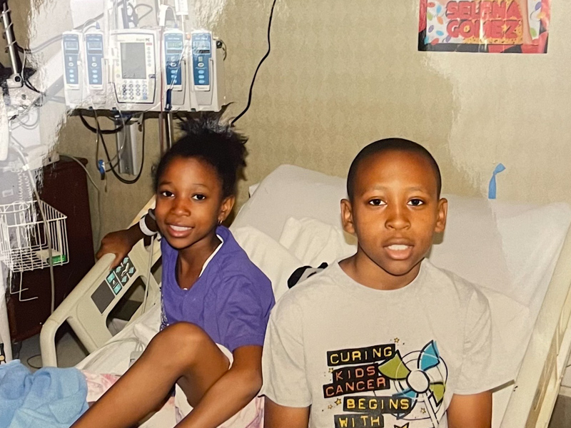 Brandon I. Dorsey Jr. (BJ), shown with Logan, was a donor and supporter of his sisters during their bone marrow transplants.