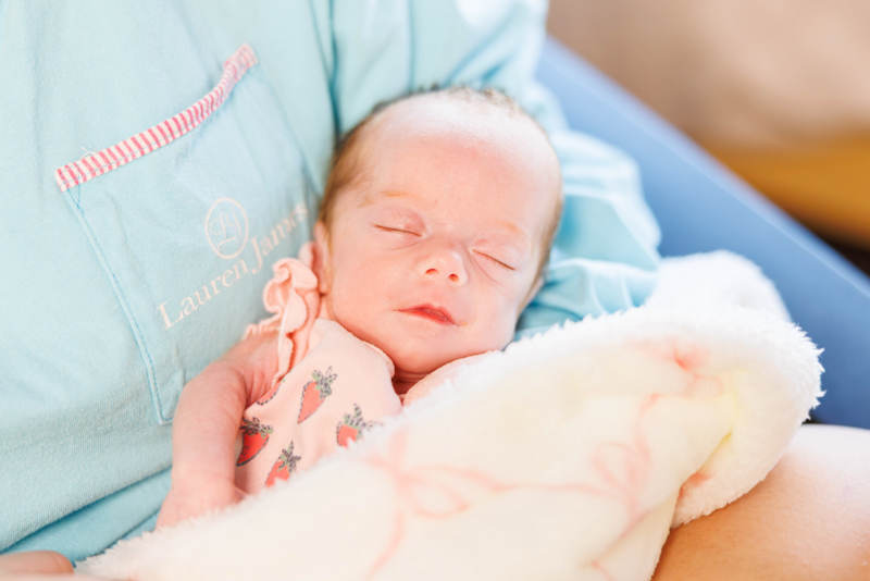 Children's of Mississippi NICU patient Avana Rushing sleeps in her mother's arms.