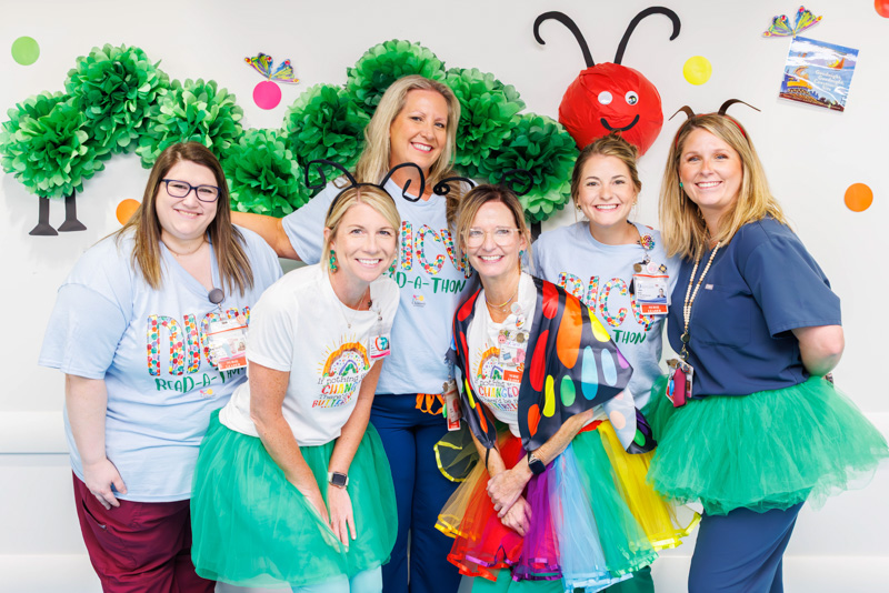 Among the NICU care team members cheering on reading are, back, from left, Lauren Cox and Becky Harrison, nurse educators; Caitlyn Baney, clinical outcomes coordinator; Sissy Frost, director of nursing-NICU; and front, Slay Jeffords and Ann Adams, NICU nurse managers.