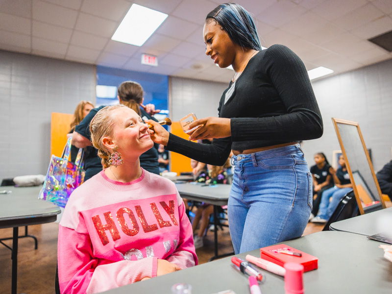 Smith County Career Center student Honesty gives Holly Ware a holiday glow.