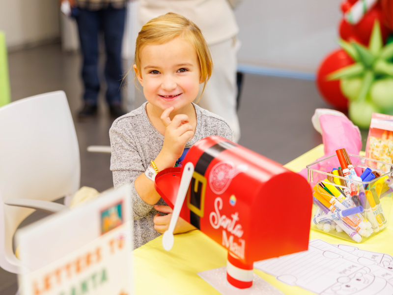 Bristol Foster, 5, of Louisville, writes her Christmas wish list to Santa Claus at Santa's Workshop. Melanie Thortis/ UMMC Communications