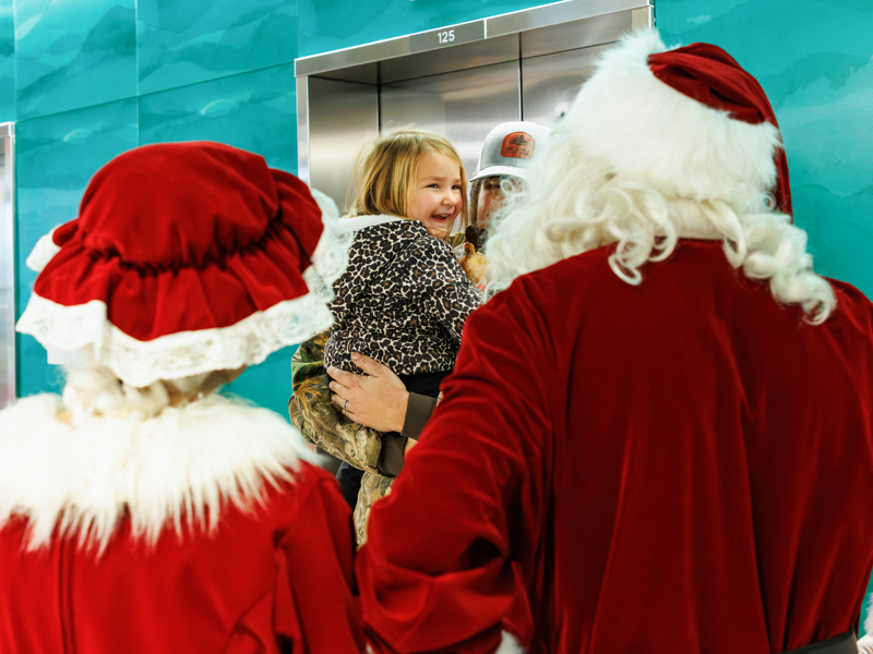 Hannah Gustavsen, 3, of Louisville, tells Santa and Mrs. Claus her wishlist at Children's of Mississippi. Melanie Thortis/ UMMC Communications