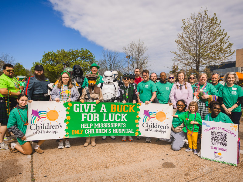 The 2026 City Sweep volunteers gear up to walk the Hal's St. Paddys parade route to collect donations for beads benefitting the children's hospital. Lindsay McMurtray/ UMMC Communications