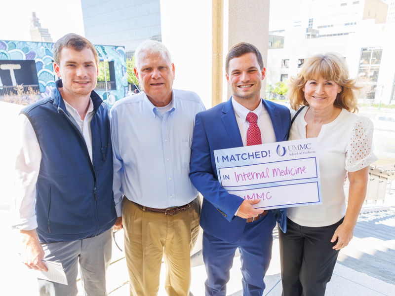 Michelletti poses with his borther, Eric, and parents Dewey and Lisa Michelletti, following the School of Medicine Match Day.