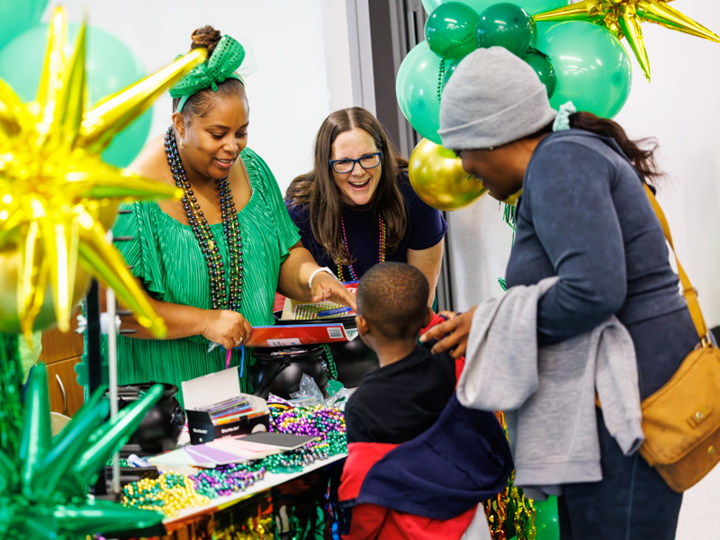 Jireh Bryant, 4, of Jackson and his mom Candice Bryant receive prizes from Sandy Quinn and Melody Moody Thortis with the Community Foundation of Mississippi at the 2026 Petite Parade at the children's hospital. Melanie Thortis/ UMMC Communications