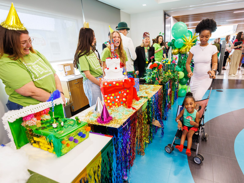 Malla Powell, 4, of Jackson partakes in the fun with her mom Angelica May and members of the TELL Agency, from left, Erin McKewen, Brennan Hight and Abi-Leigh Doss at the 2026 Petite Parade at the children's hospital. Melanie Thortis/ UMMC Communications