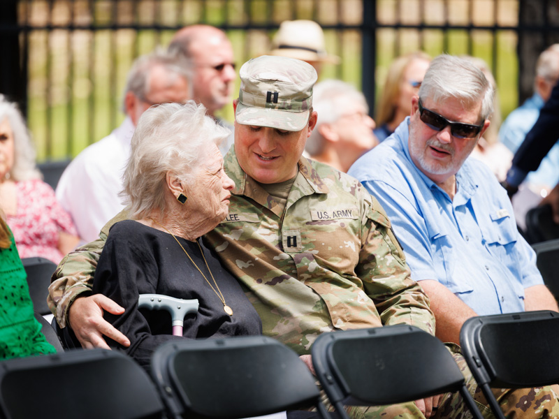 Joyce Easley, left, chats with her grandson Capt. Eric Lee and son-in-law, Larry Lee, before the start of Wednesday's Ceremony of Thanksgiving.