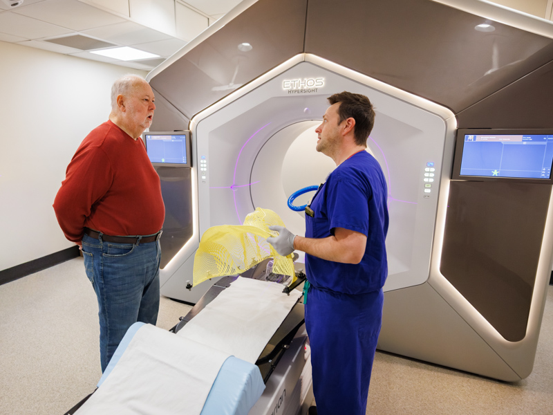 Patrick McCarthy of Jackson, among the first Mississippians to use the Ethos system at UMMC, talks with Jeffery Kent, radiation therapist.
