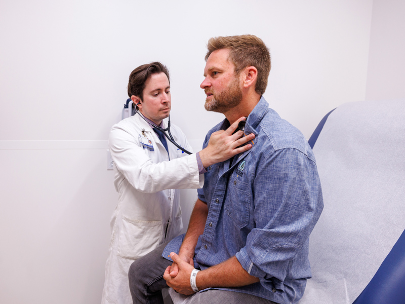 Dr. Bradley Deere, associate professor of cardiology, examines John Decker in a follow-up appointment.